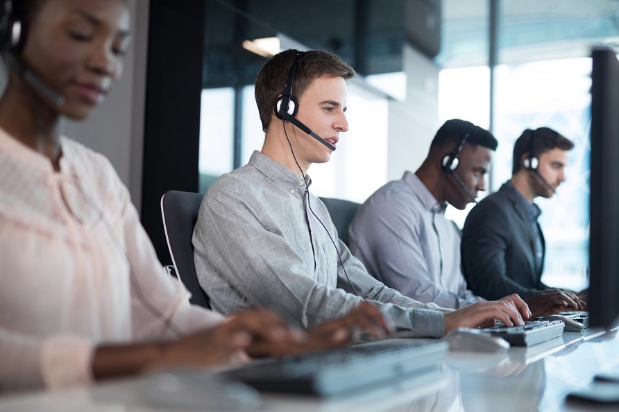 Attentive customer service executives working at office